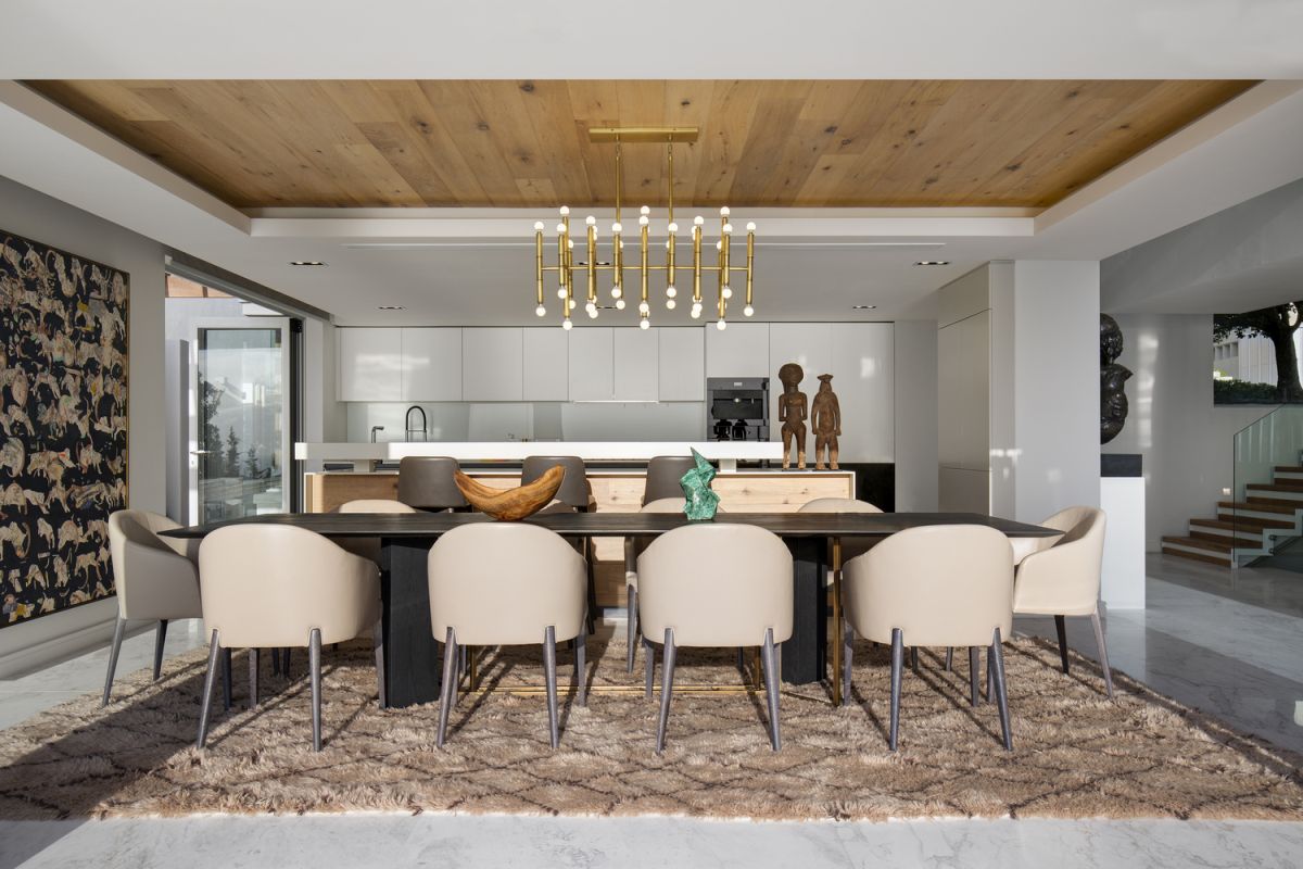 The soft texture of the area rug combined with the metallic chandelier and wooden ceiling looks amazing