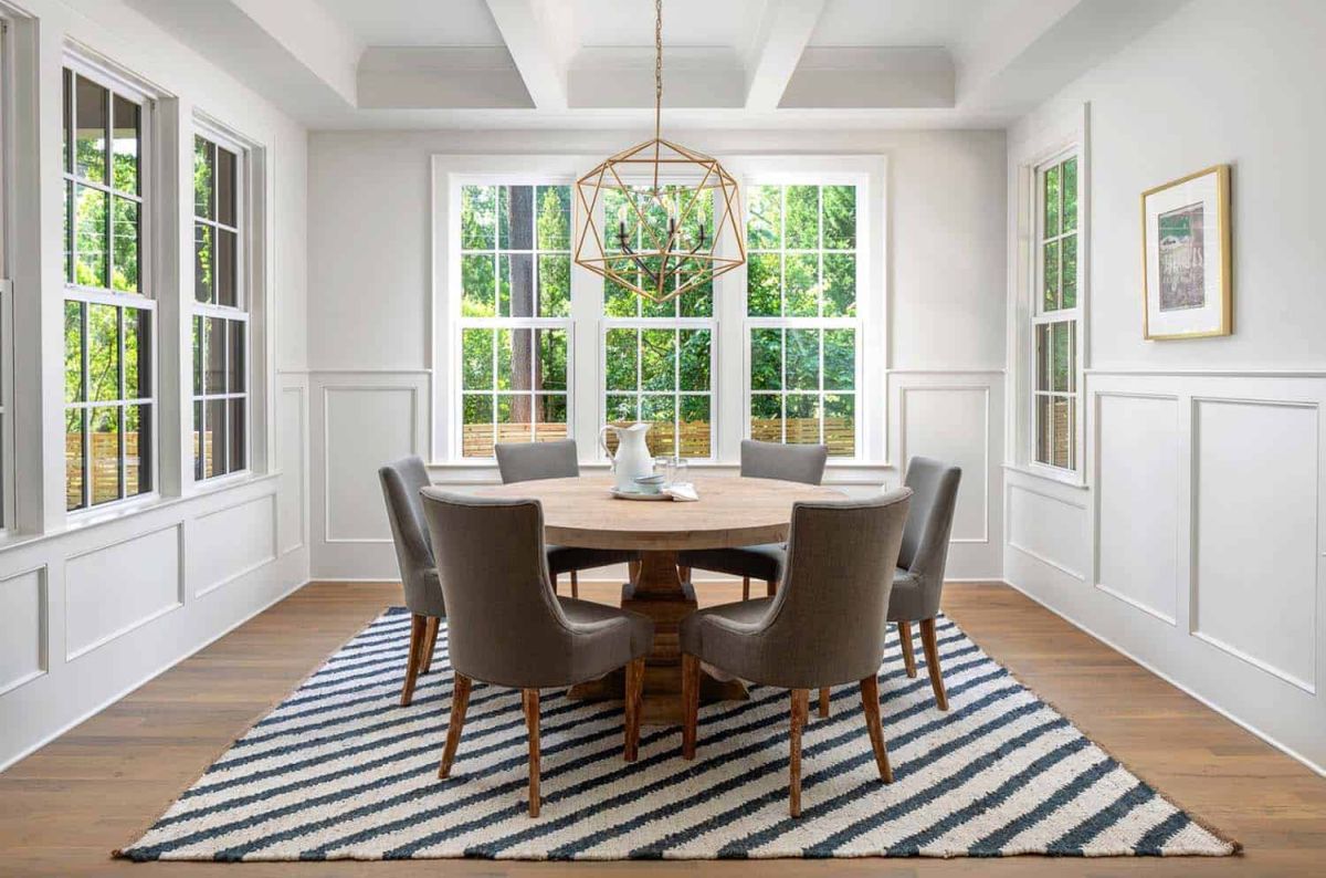 The dining area is wonderful, featuring a round table and large windows