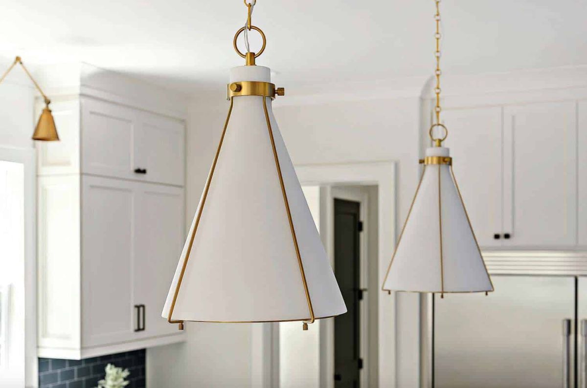 The white walls and furniture are complemented by stylish metallic touches