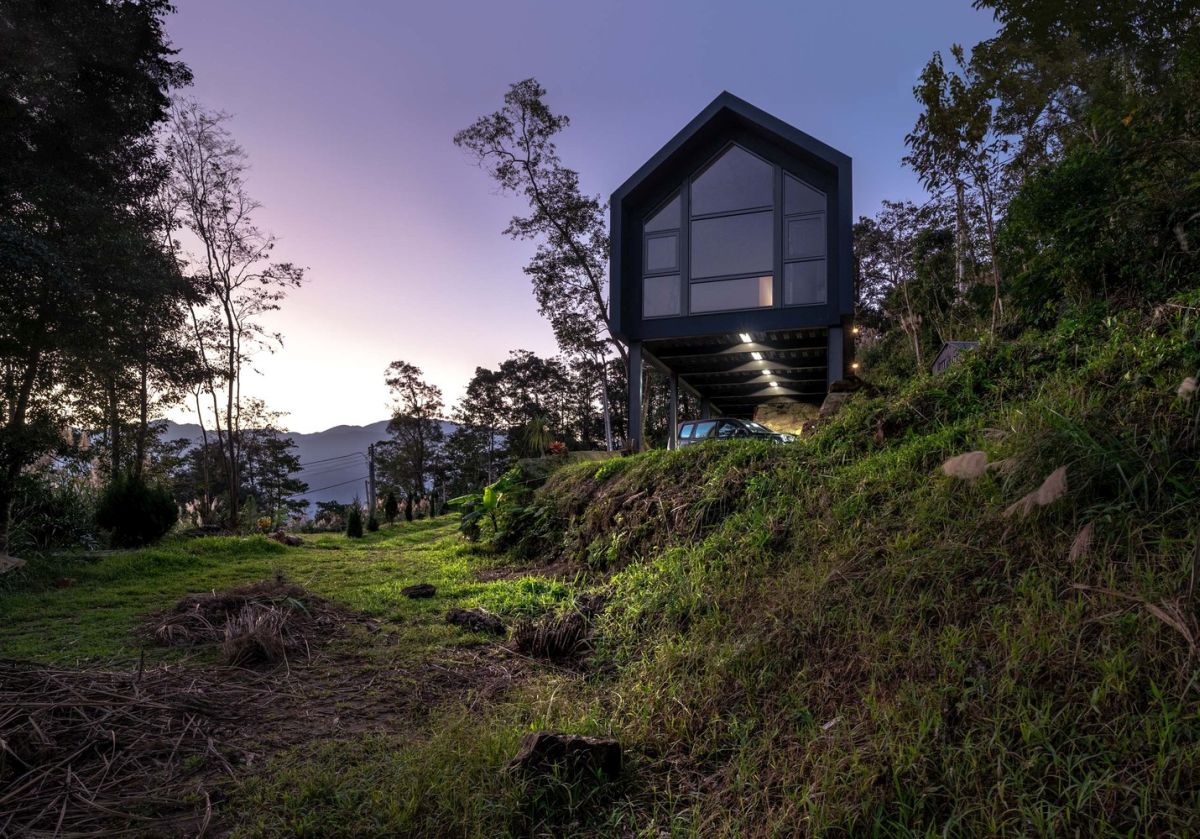 The minimalist house extends over the rugged terrain, overlooking the two valleys which frame it