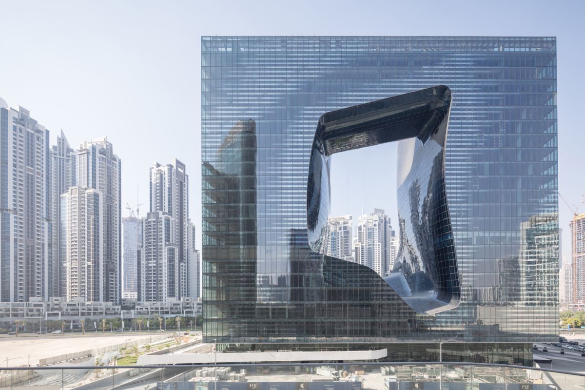 The clean geometric shape of the building contrasts with the freeform cut-out at the center