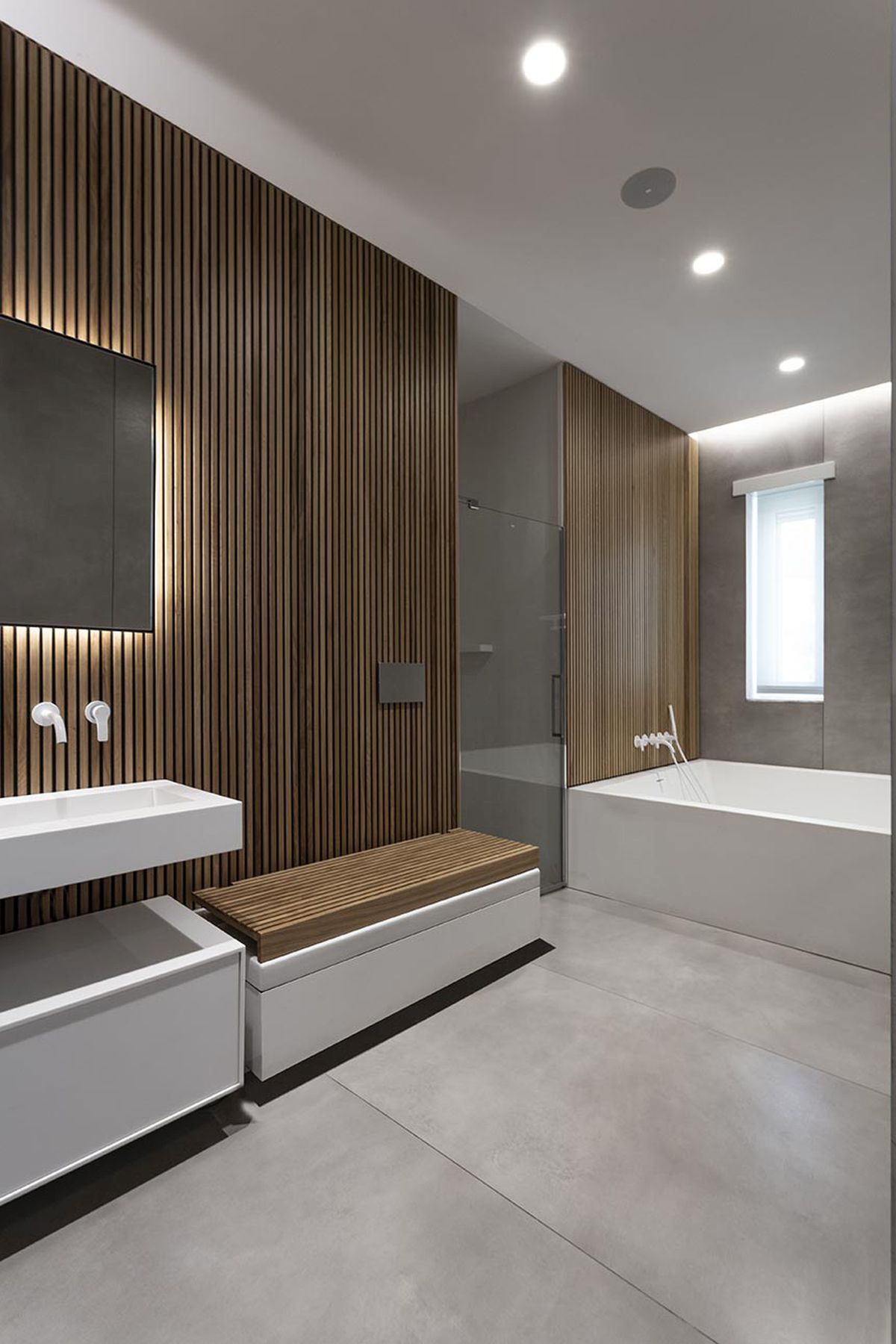 The wood accents and spacious layout give the bathroom a very welcoming and sophisticated look