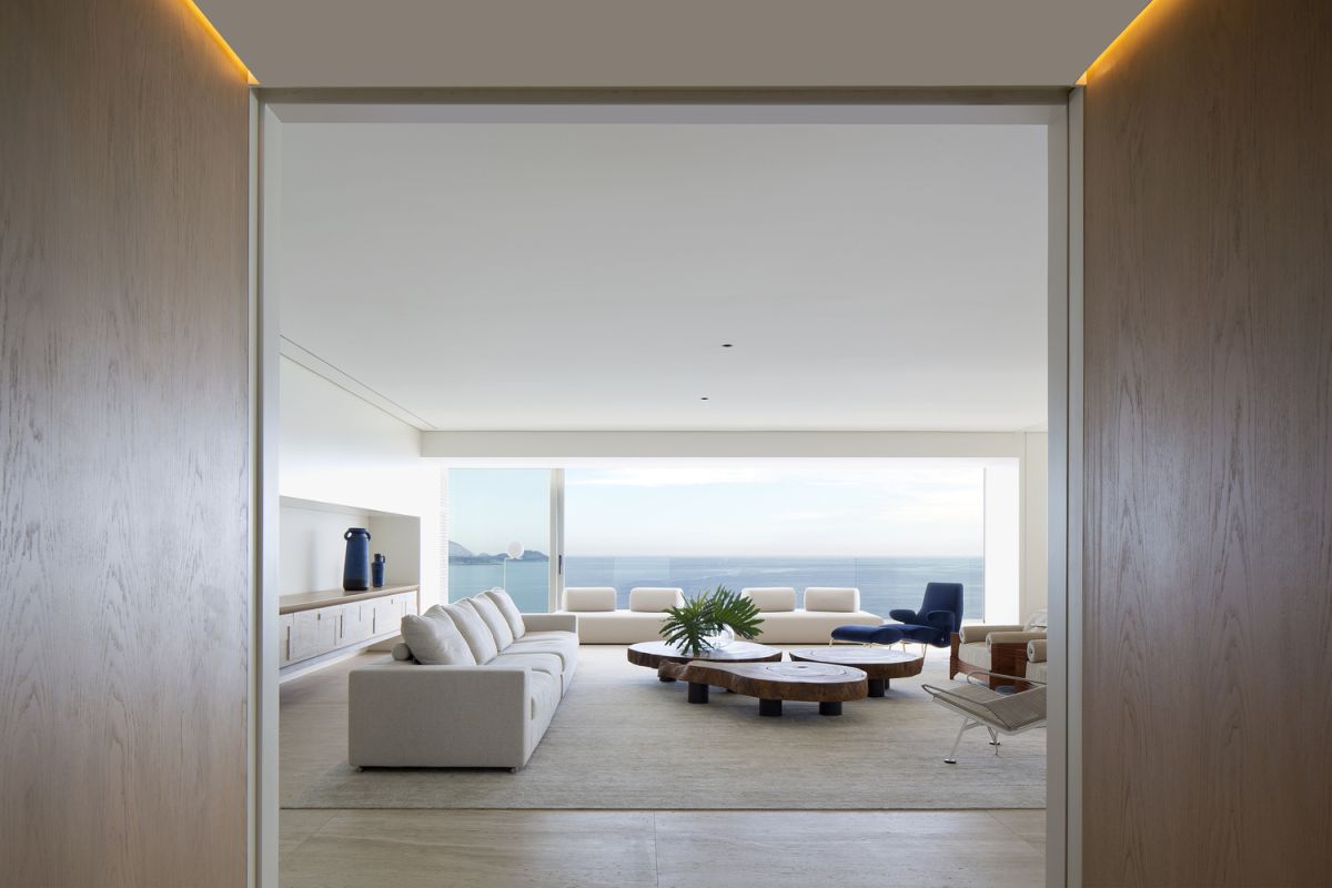 The living area opens onto a balcony which overlooks the ocean