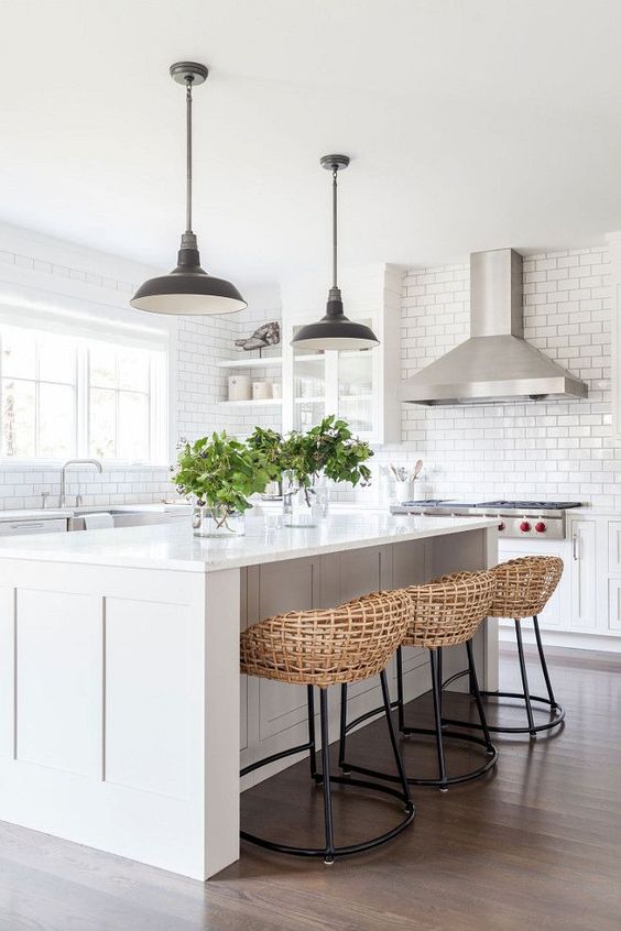 all white kitchen with rattan stools