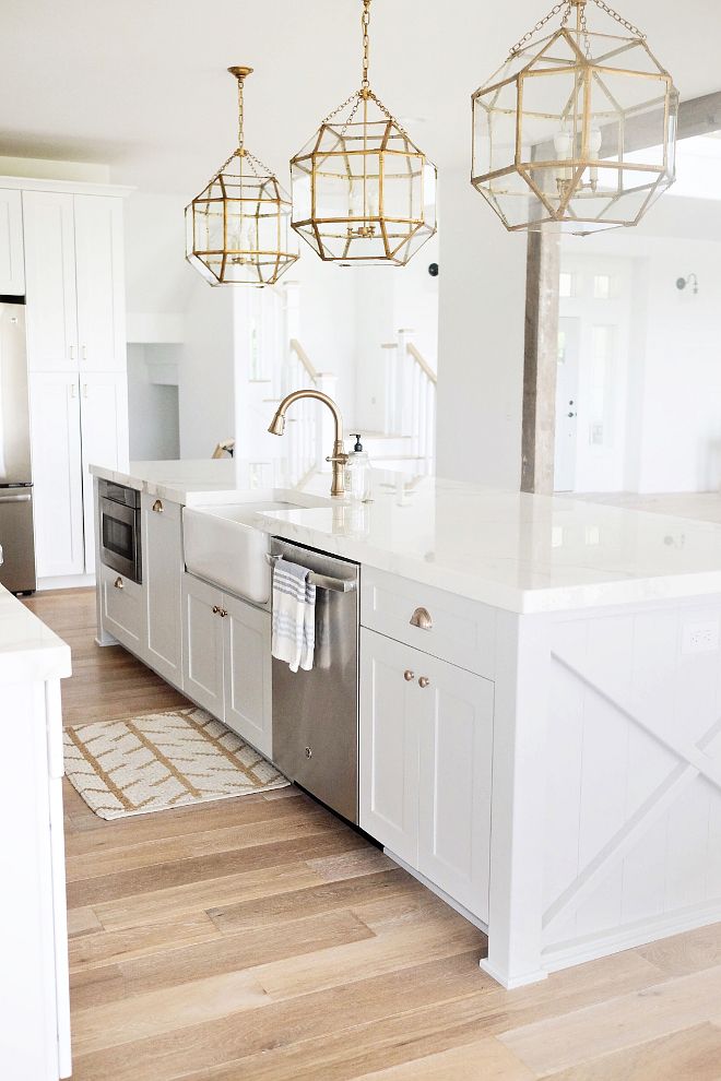 all white kitchen with gold lighting