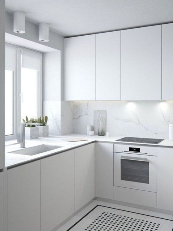 modern all white kitchen with marble backsplash