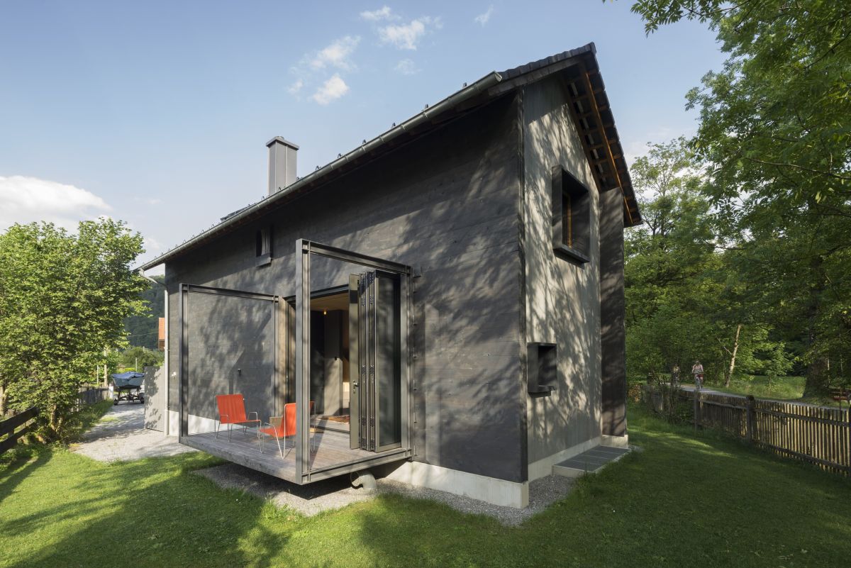 The overall design and architecture of the house are modern with influences from rustic cabins