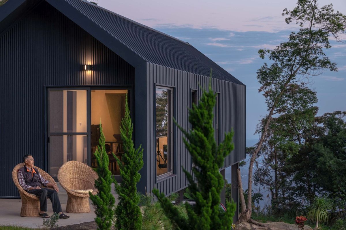 The facades and roof of the house are covered in metal sheets, giving the structure an industrial flair
