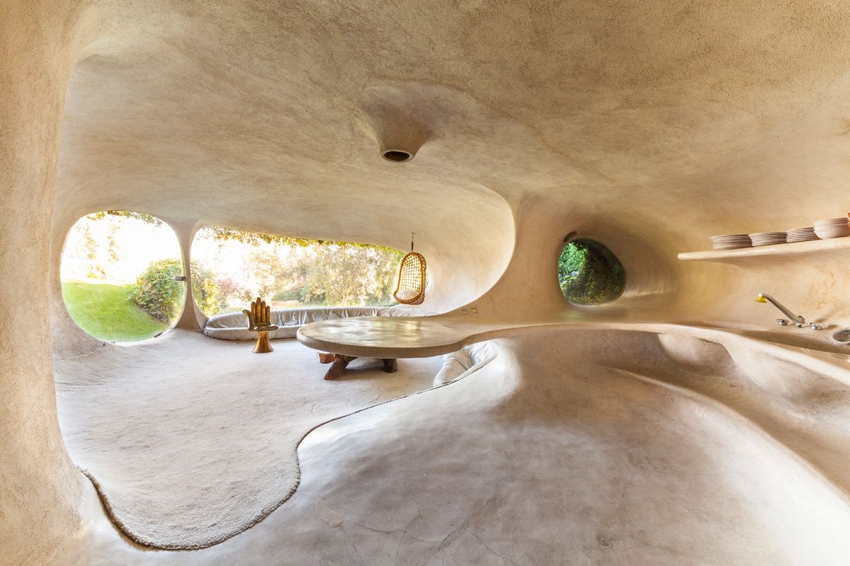 Inside, the house has a cave-like vibe with organically-shaped spaces, uniquely sculpted