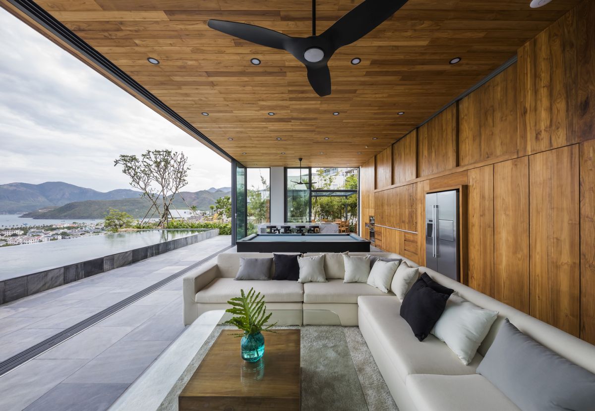 The social area opens up to the outdoors, taking in the majestic beauty of the ocean and the mountains