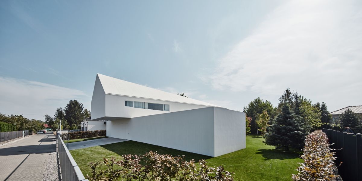 The side of the house facing the street was designed to offer as much privacy as possible and has no windows or openings
