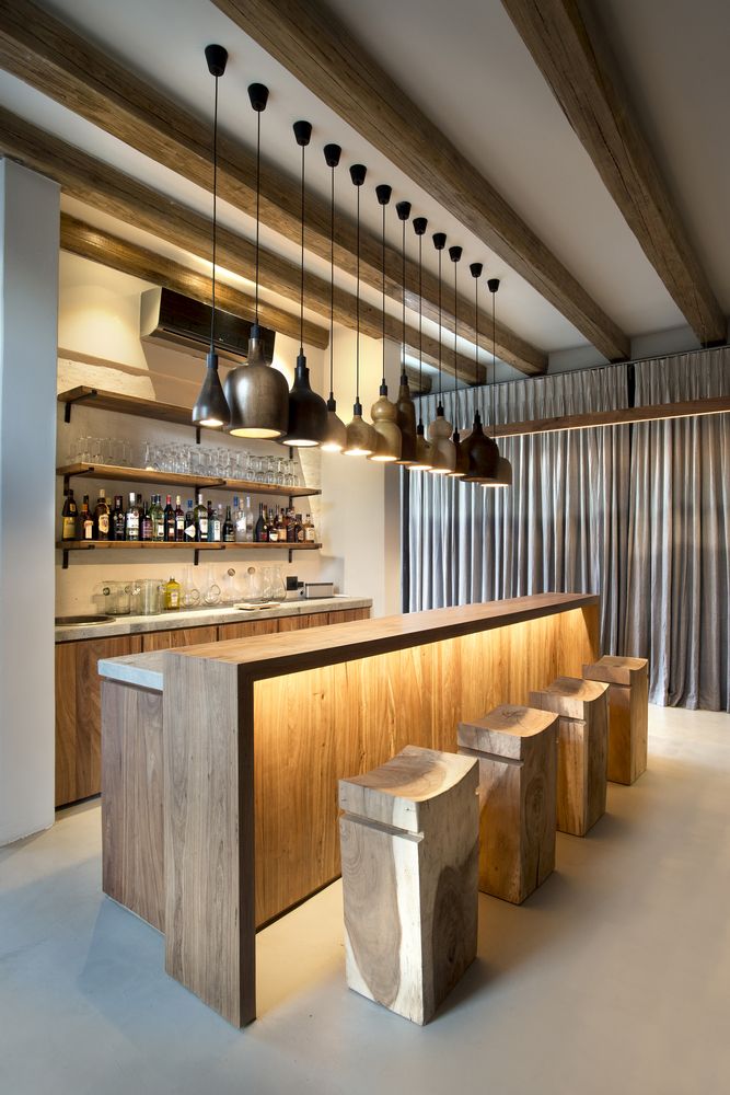 The bar area is quite chic, with a multitude of pendant lamps lined up and stylish chairs