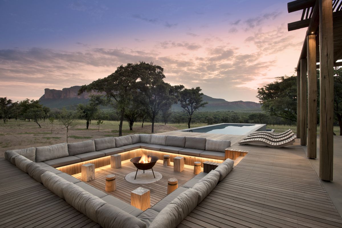 The outdoor sitting area is built into the wooden deck and has accent LED lighting