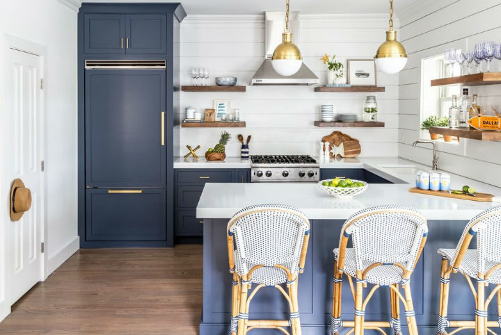 blue kitchen with peninsula and french stools