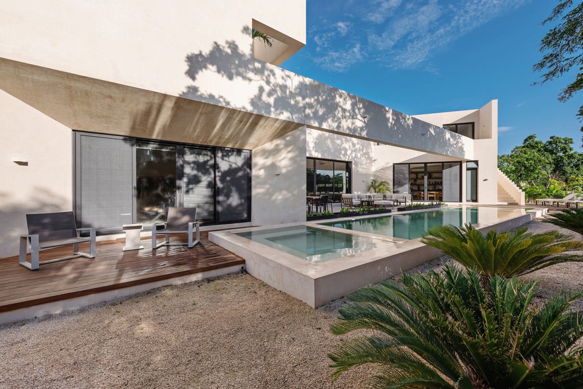 A smaller slightly elevated terrace sits in the continuation of the pool, complementing it
