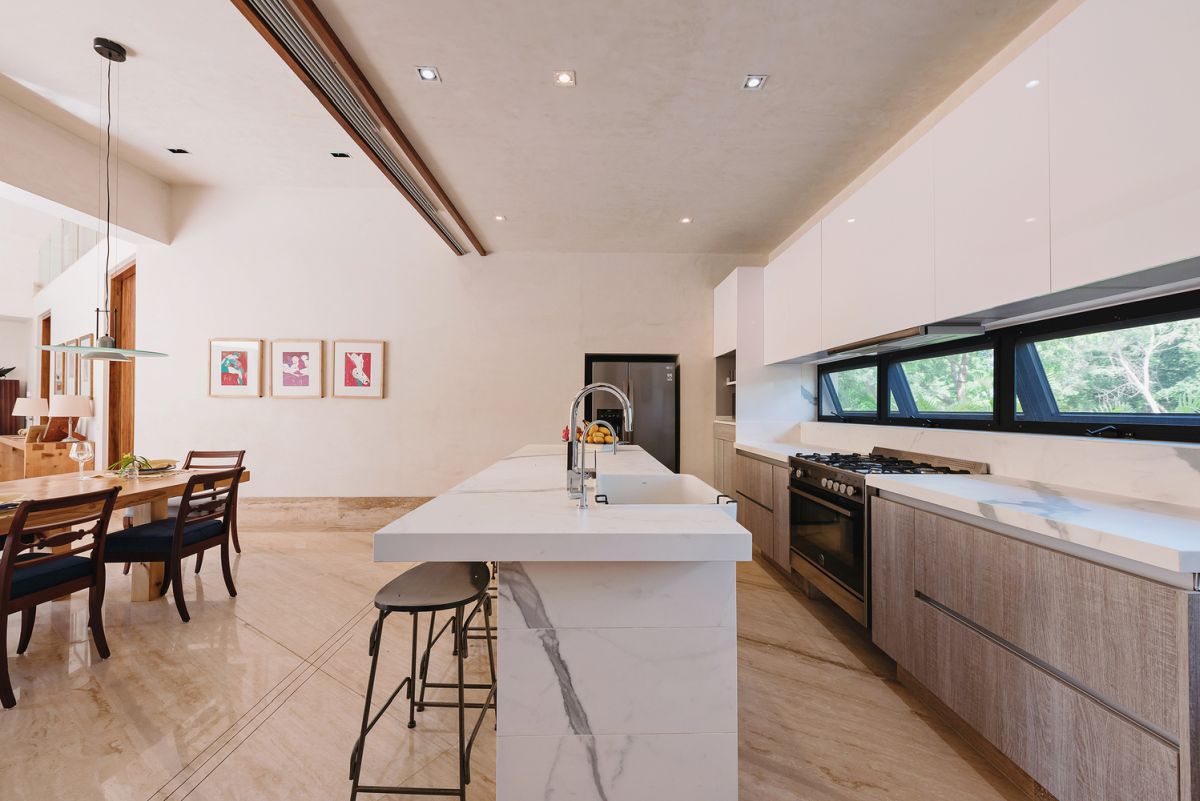 The white marble kitchen island contrasts with the rest of the decor and adds an elegant touch to the space