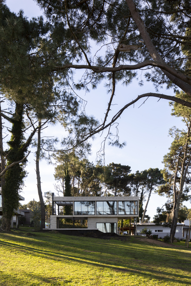 Even though it has a solid concrete base, the house still manages to look as if it's floating above the ground