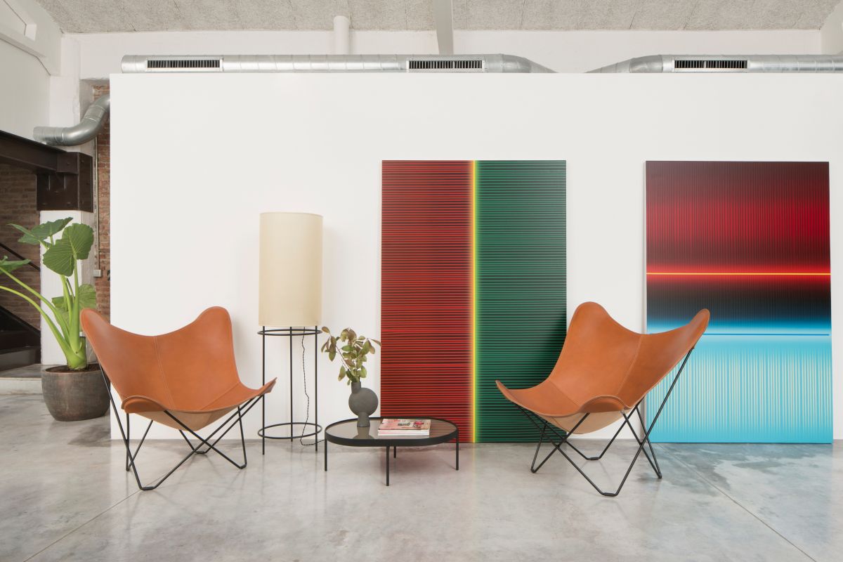 A pair of iconic Butterfly chairs create an intimate sitting area within the open floor plan