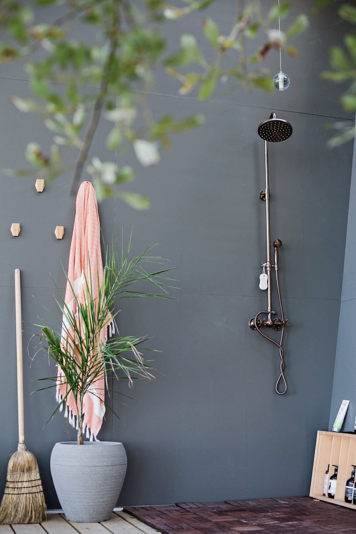 An outdoor shower is tucked away on one side of the patio and was one of the features requested by the owners