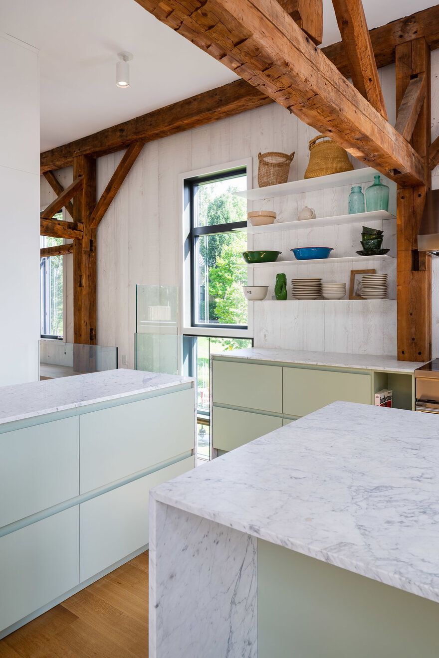 The white marble counters add an elegant and timeless vibe to the kitchen and go well with the wooden elements