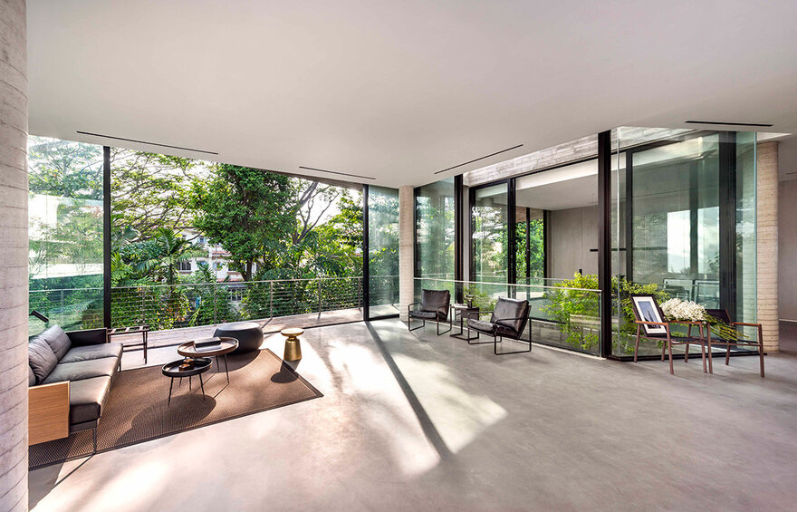 The full-height windows and large glass doors let in lots of sunlight while also letting the outdoors in