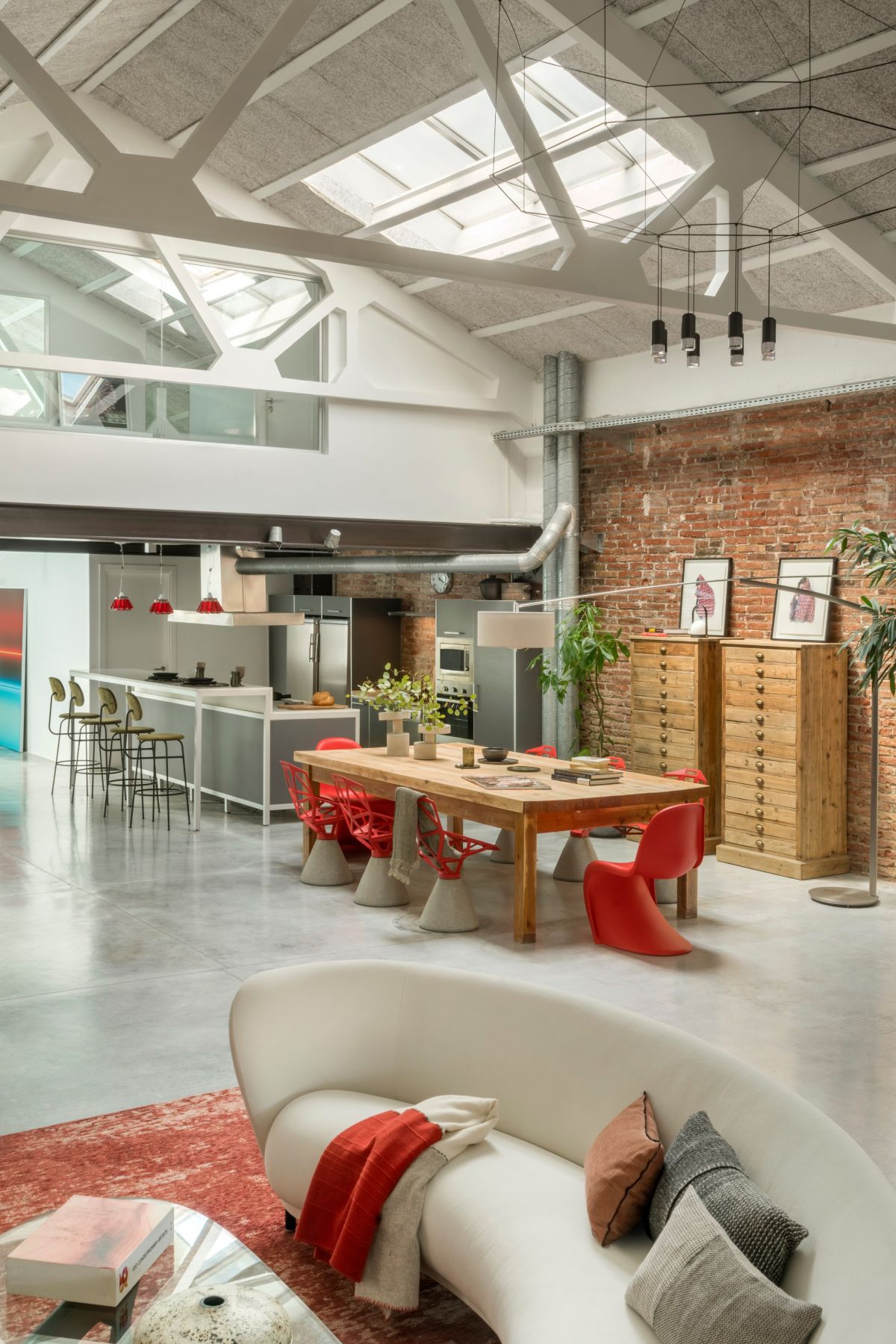 The double-height space is organized into several different area each with a specific function