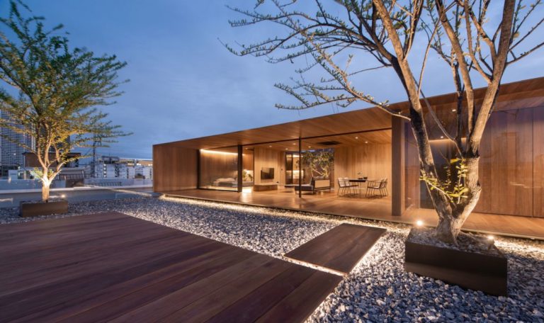 A Charming Wooden House Sits On The Rooftop Of An Apartment Building