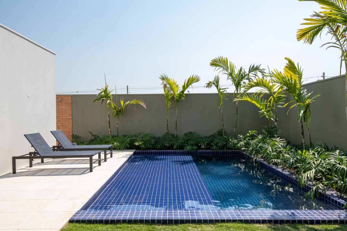 The swimming pool and adjacent deck occupy this corner and are framed by privacy walls