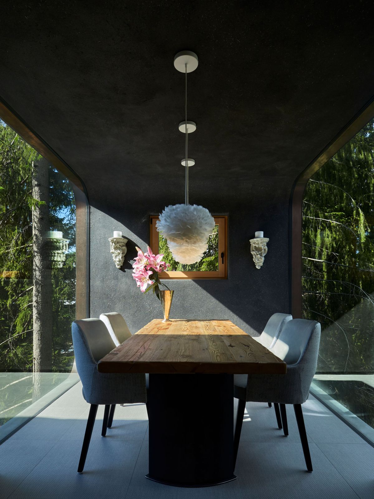 The dining room is exquisite, being framed by full-height windows on two sides