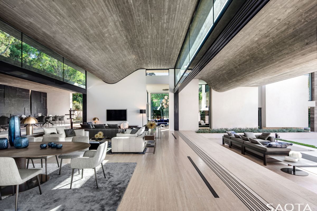 A retracting glass wall separates the interior and exterior volumes while maintaining visual connection between them