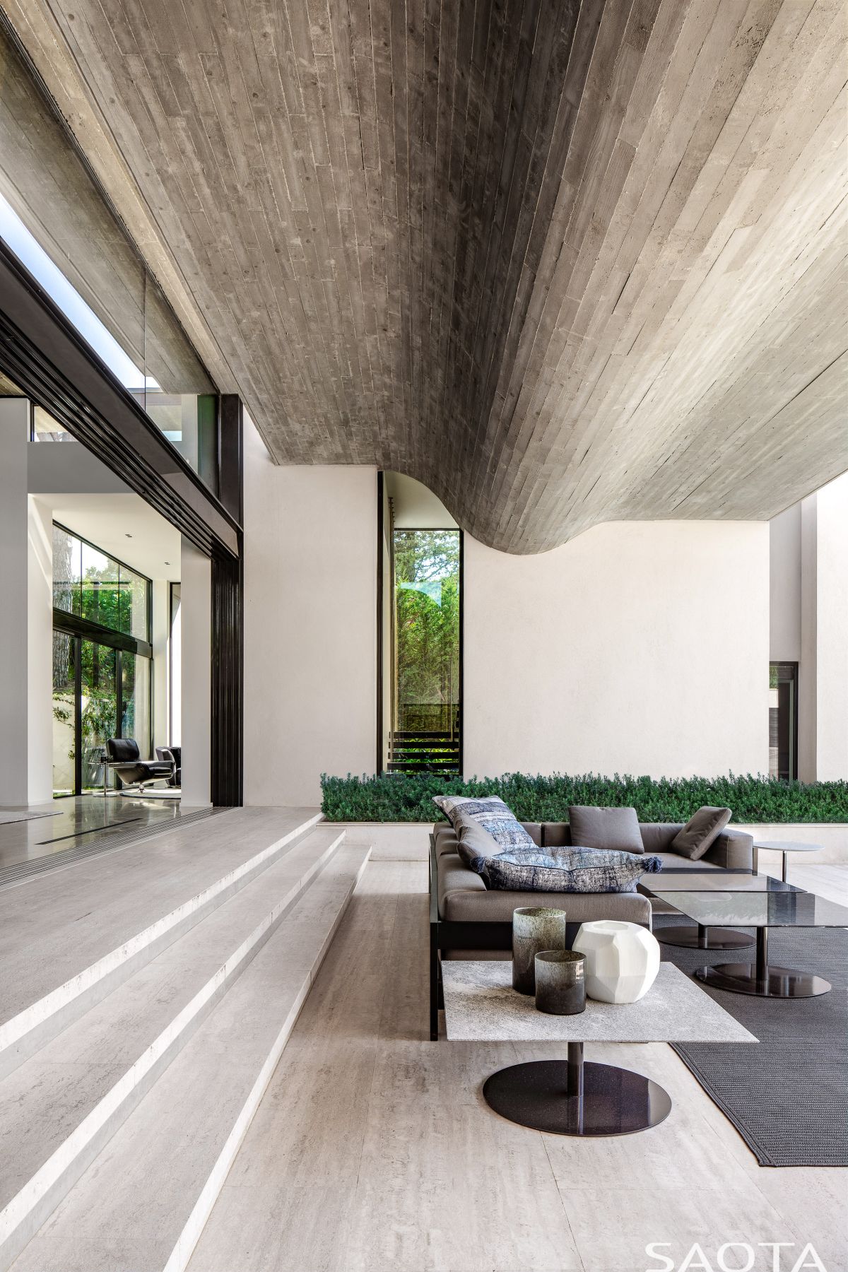 The roof here is made of raw wooden planks which reference the pine trees
