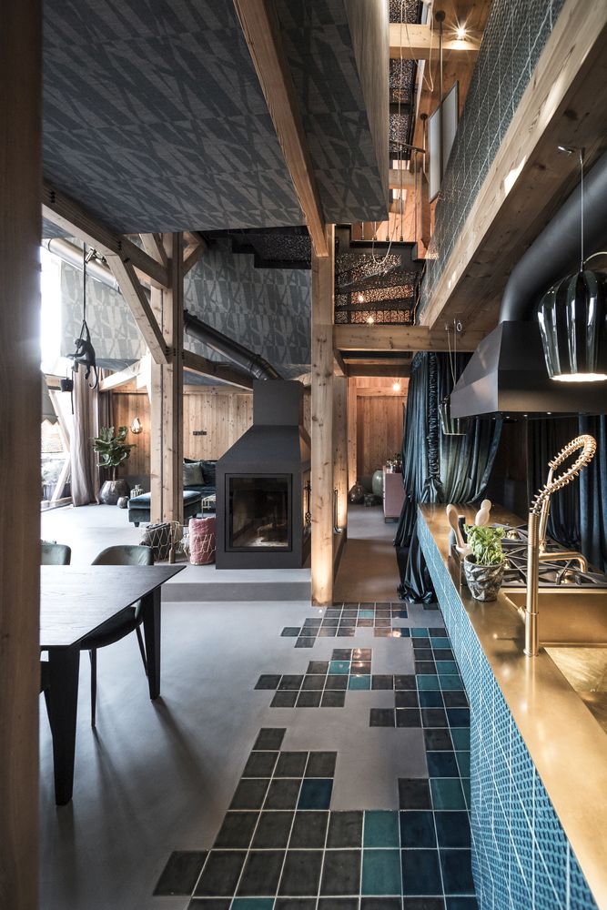 The kitchen transitions seamlessly into the dining room and features scattered tiles on the floor