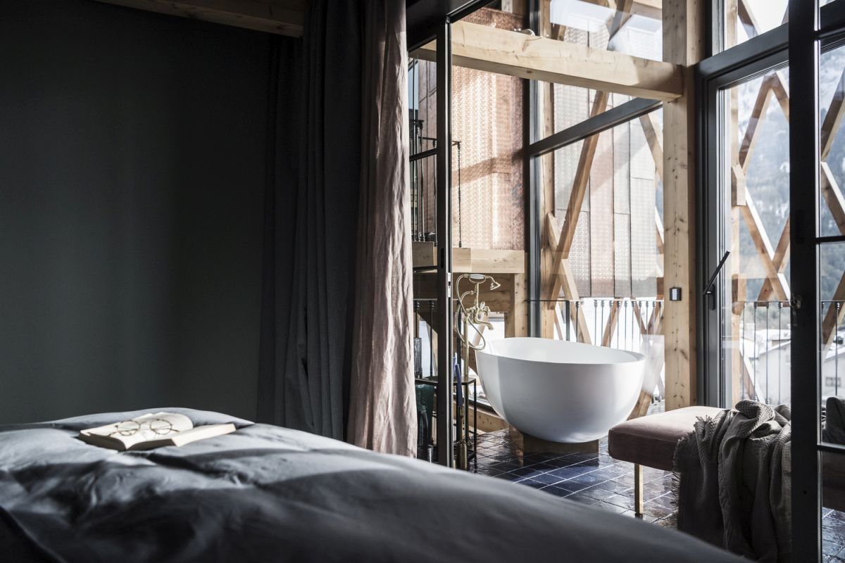 Dark color tones give the bedrooms a very cozy and intimate vibe
