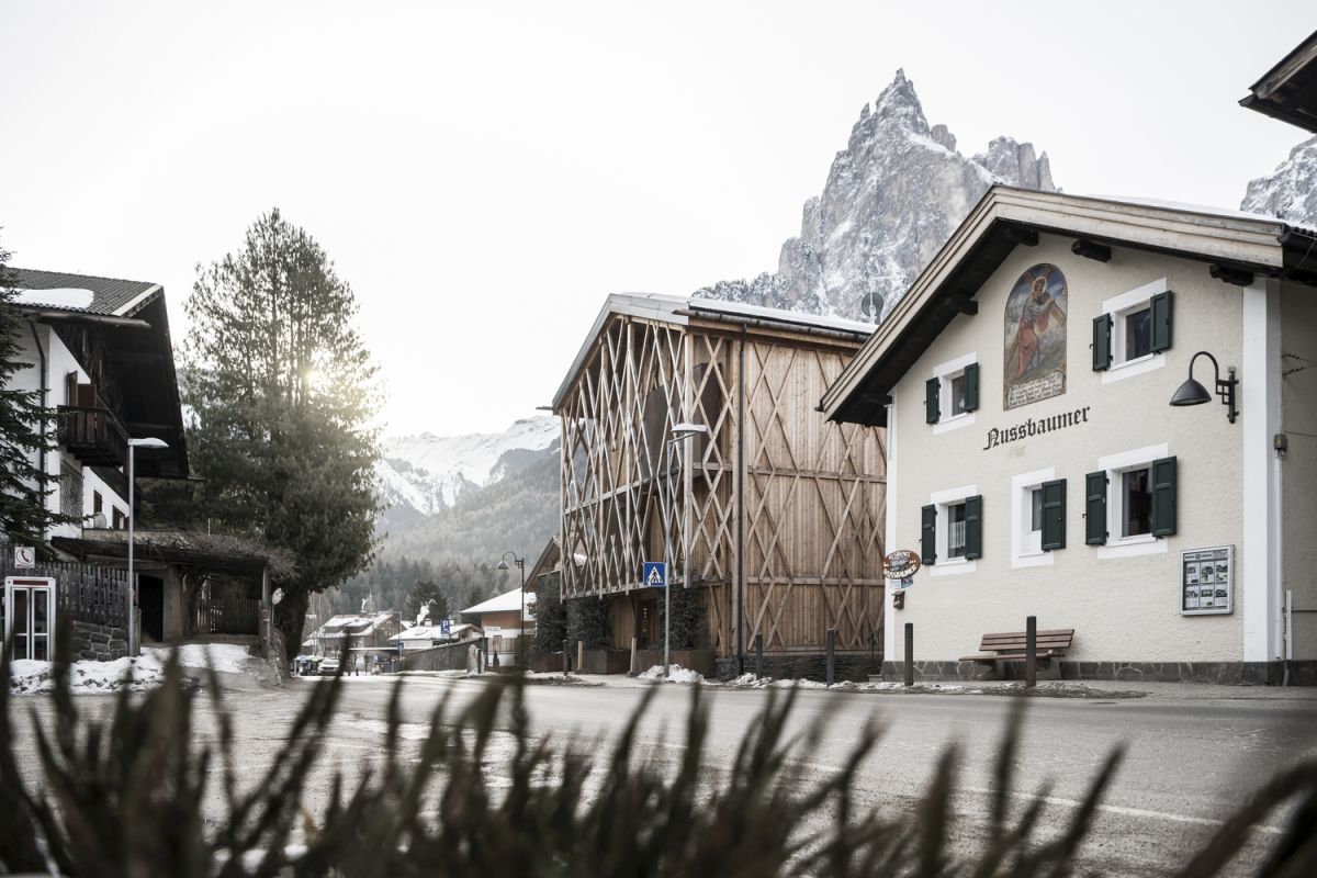 The overall proportions and shape of the house are very similar to the neighboring structures