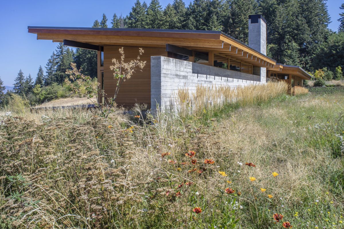 The side of the house facing South features a concrete wall designed to offer protection from the elements