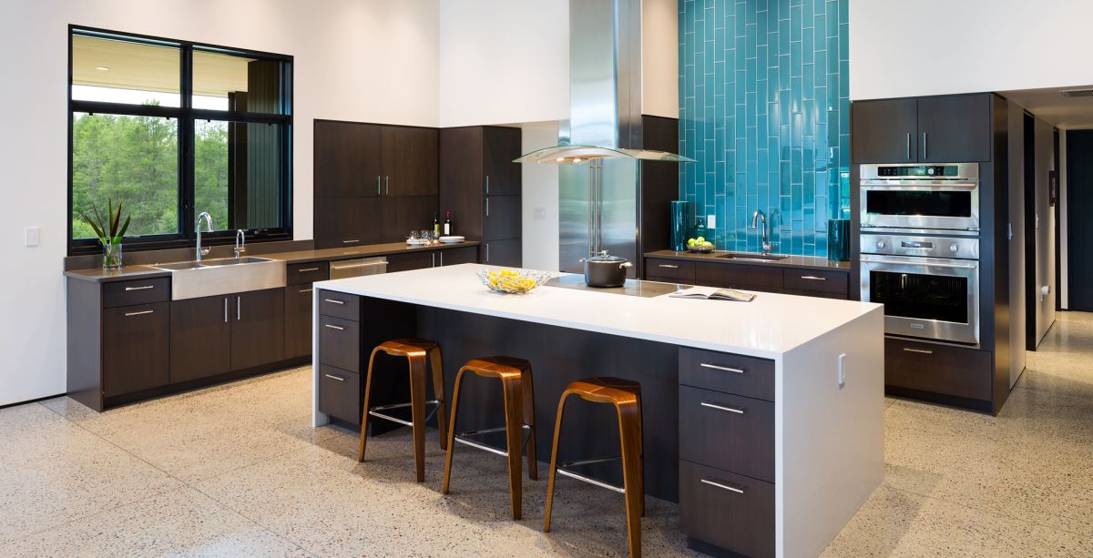 The kitchen is spacious and open and features eye-catching turquoise accents