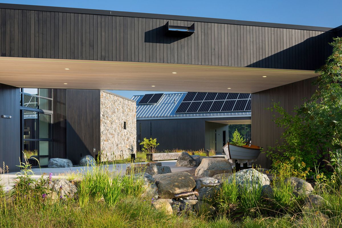 On the outside the house is clad in dark stained cedar wood and in stone, both locally-sourced