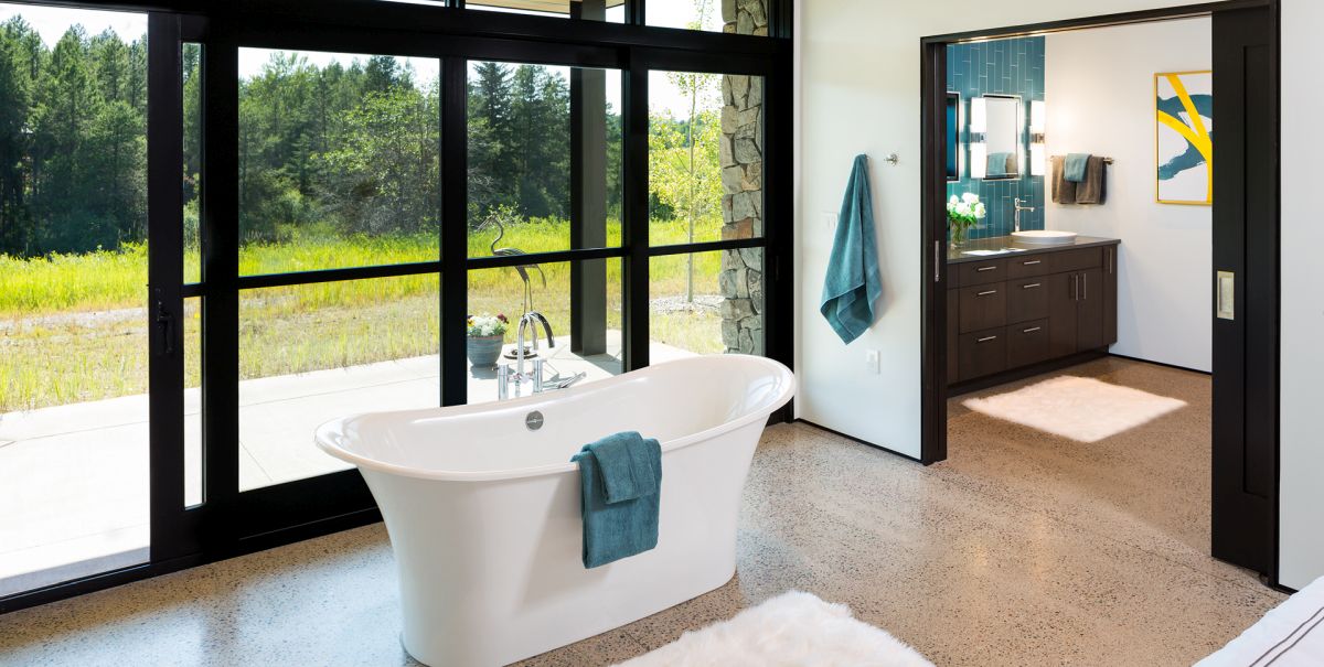 The freestanding tub is placed outside the bathroom, where it can take advantage of the scenery