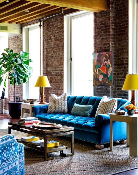living room with blue velvet tufted sofa