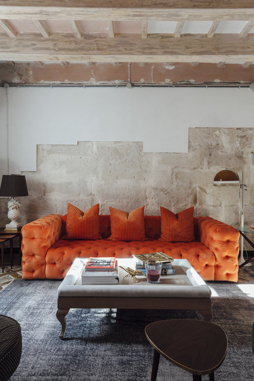 Living room with bold orange sofa