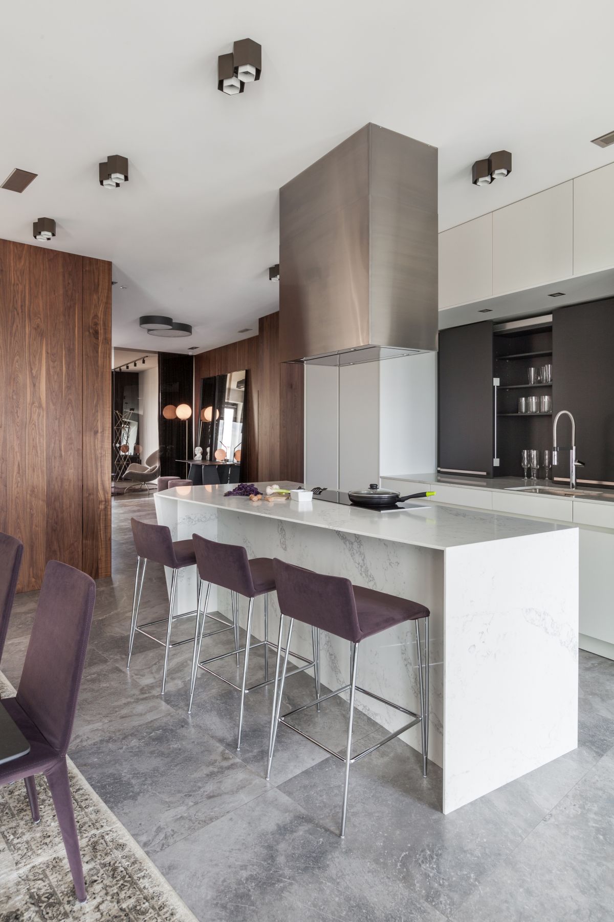 The kitchen island doubles as a bar and the stools match the dining chairs creating a smooth transition