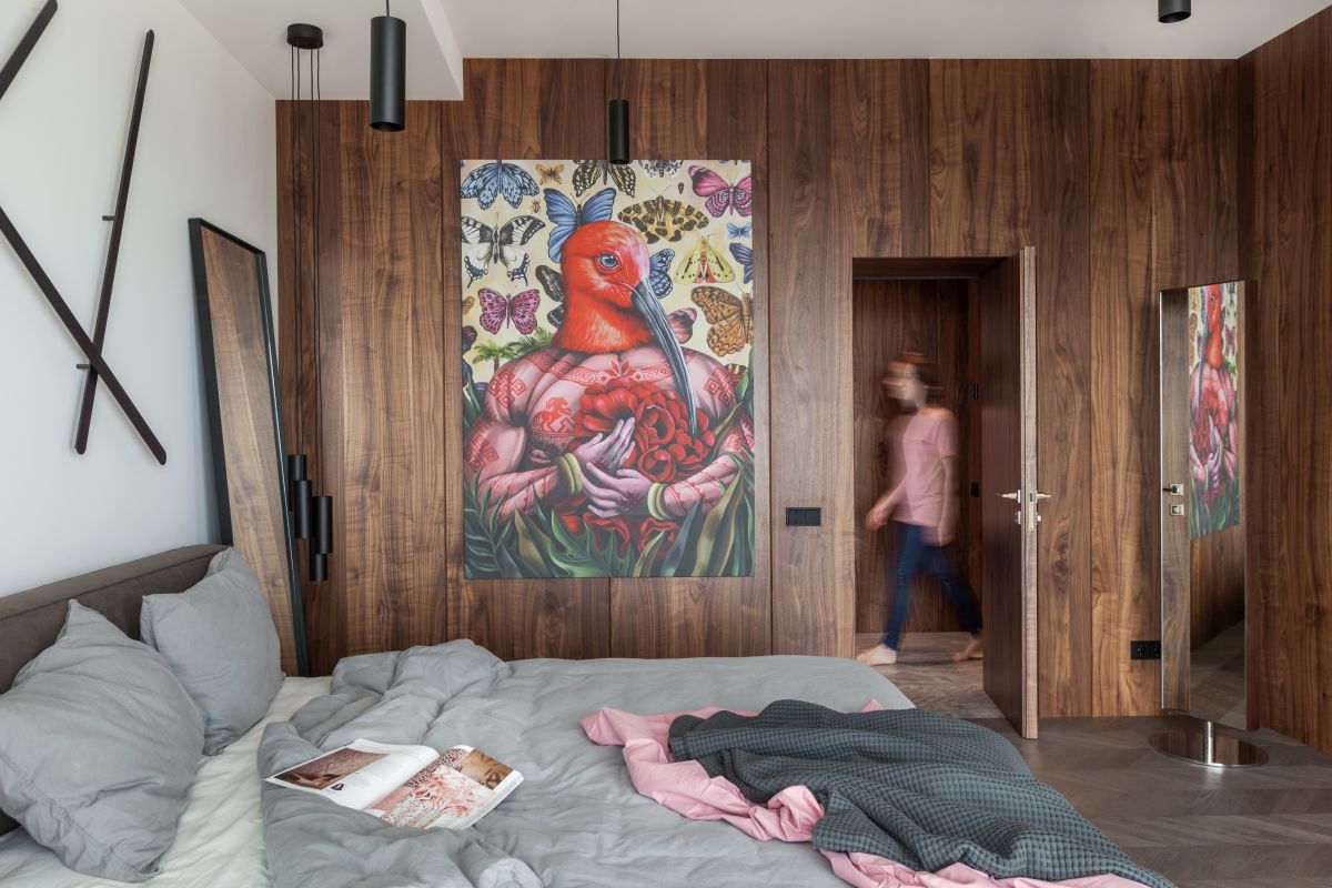 The wooden accent wall seamlessly hiden the bedroom door, creating a very smooth and cozy ambiance