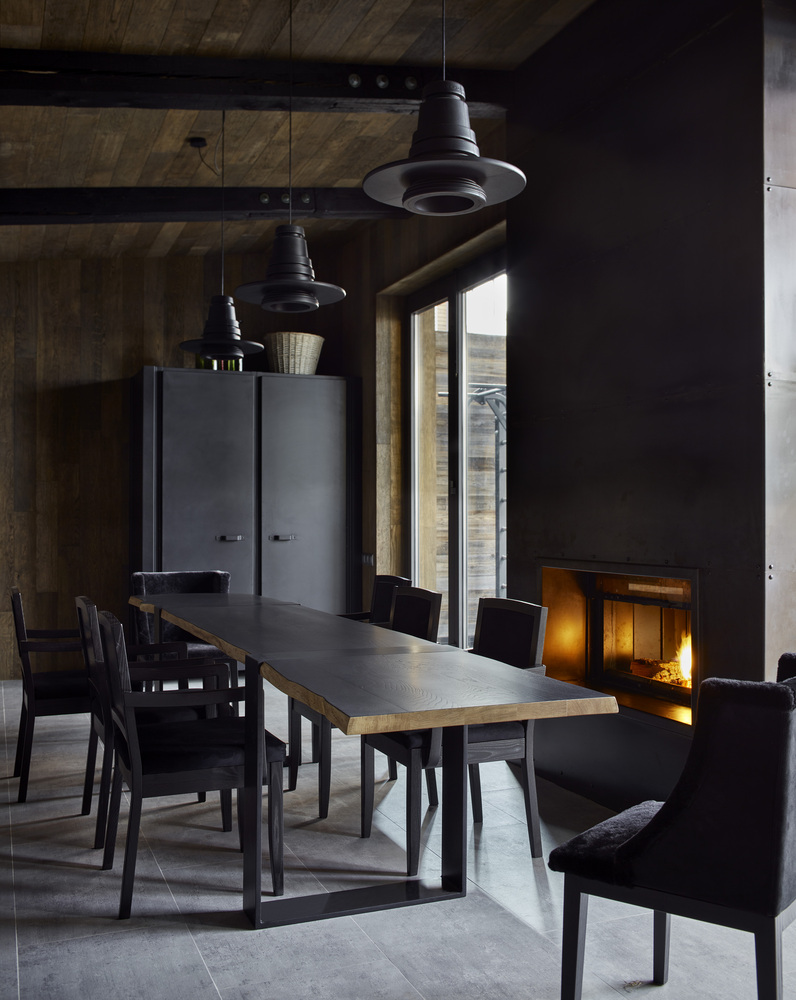 There's a dining area placed right next to the fireplace which also gets a view towards the courtyard