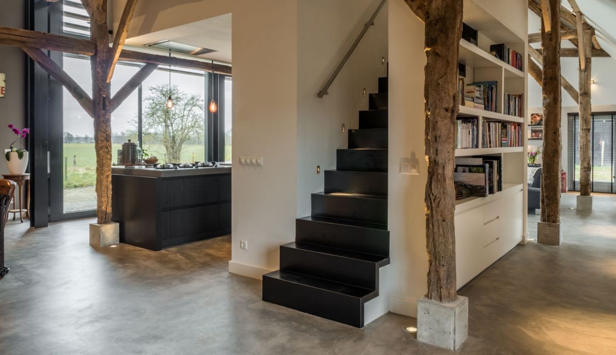 The staircase is cleverly hidden behind bookshelves, maintaining a low profile