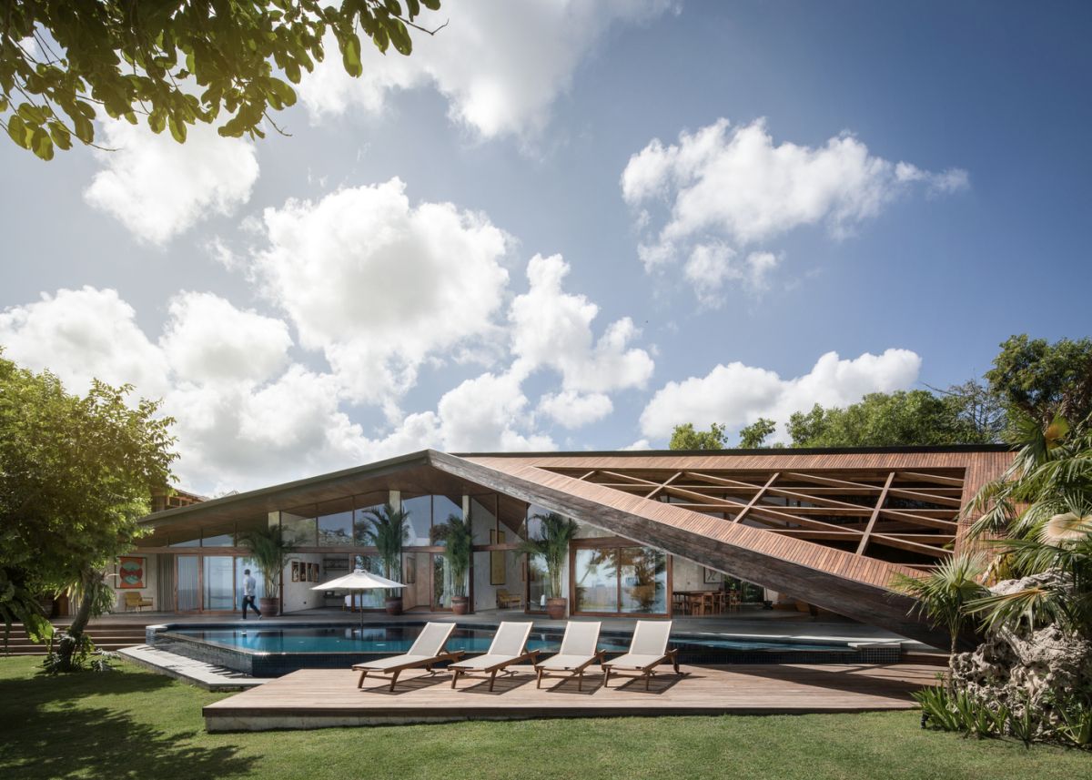 The unique, geometric roof extends the house beyond its internal boundaries