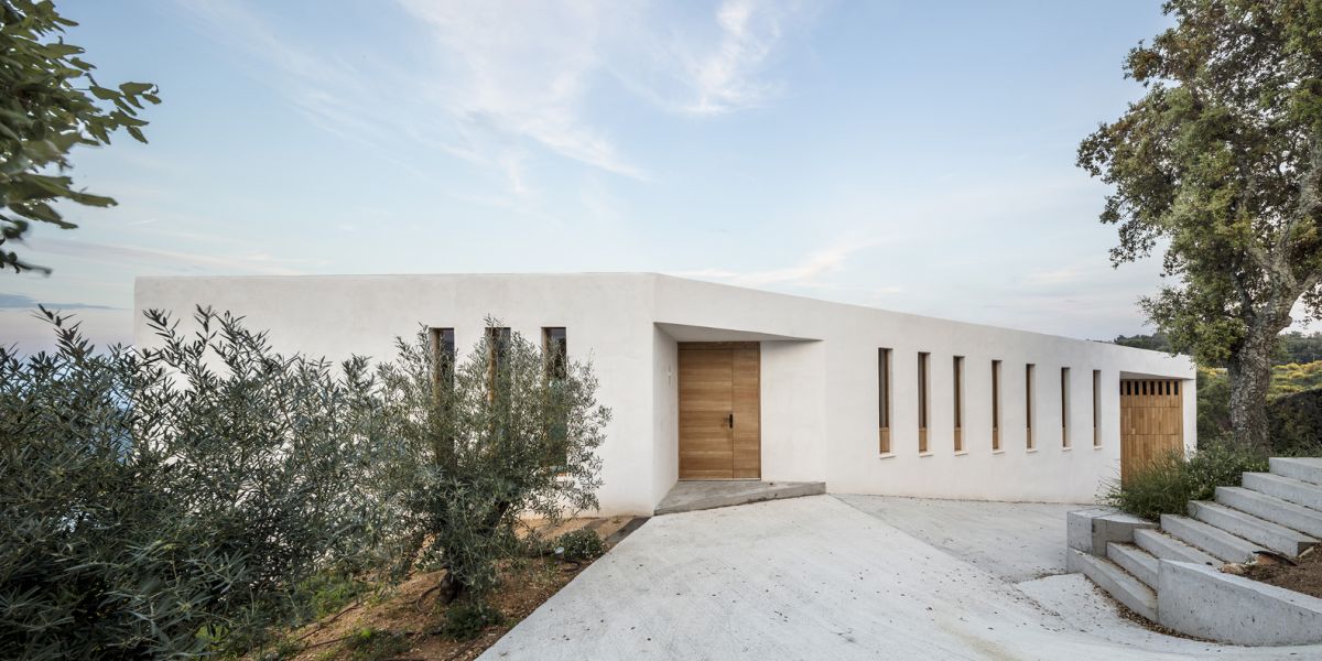 On a sunny summer day the house blends into the clear sky and almost disappears into the landscape
