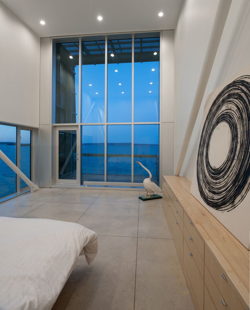 The master bedroom opens onto a covered terrace with a direct view towards the sea