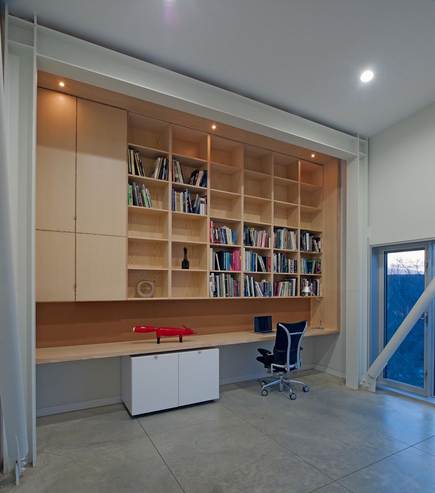 The home office has a minimalistic design just like the rest of the house and is all concentrated on one wall