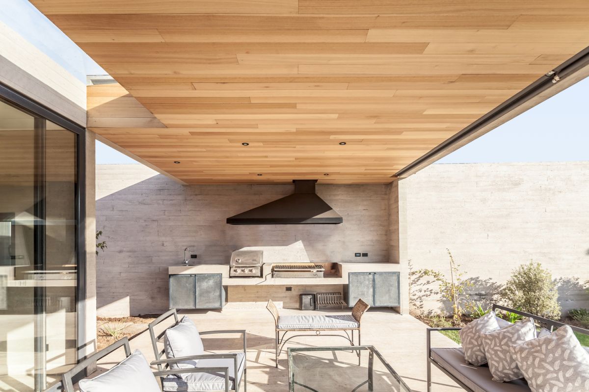 The outdoor kitchen serves as an extension of the indoor living area