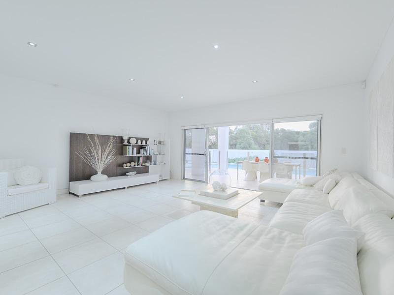 An all-white living room can end up looking cold and austere without a suitable palette of textures and finishes